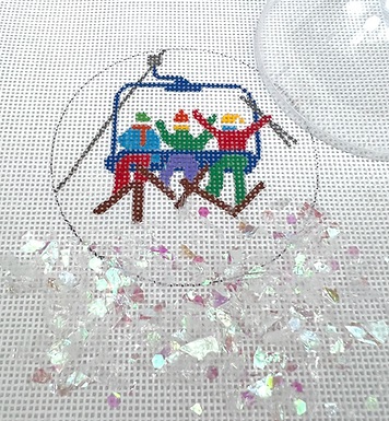 click here to view larger image of Skiers on Chairlift Ornament w/Clear Dome and Confetti (hand painted canvases 2)